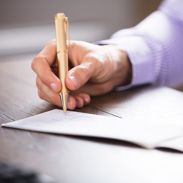 Hand signing a Business check